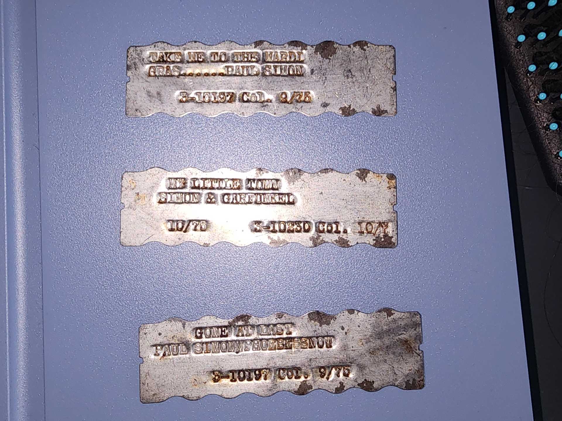 Original Concert Stamp Tags: Paul Simon & Art Garfunkel Metal Tags - "Take Me to the Mardi Gras" & "Gone at Last"