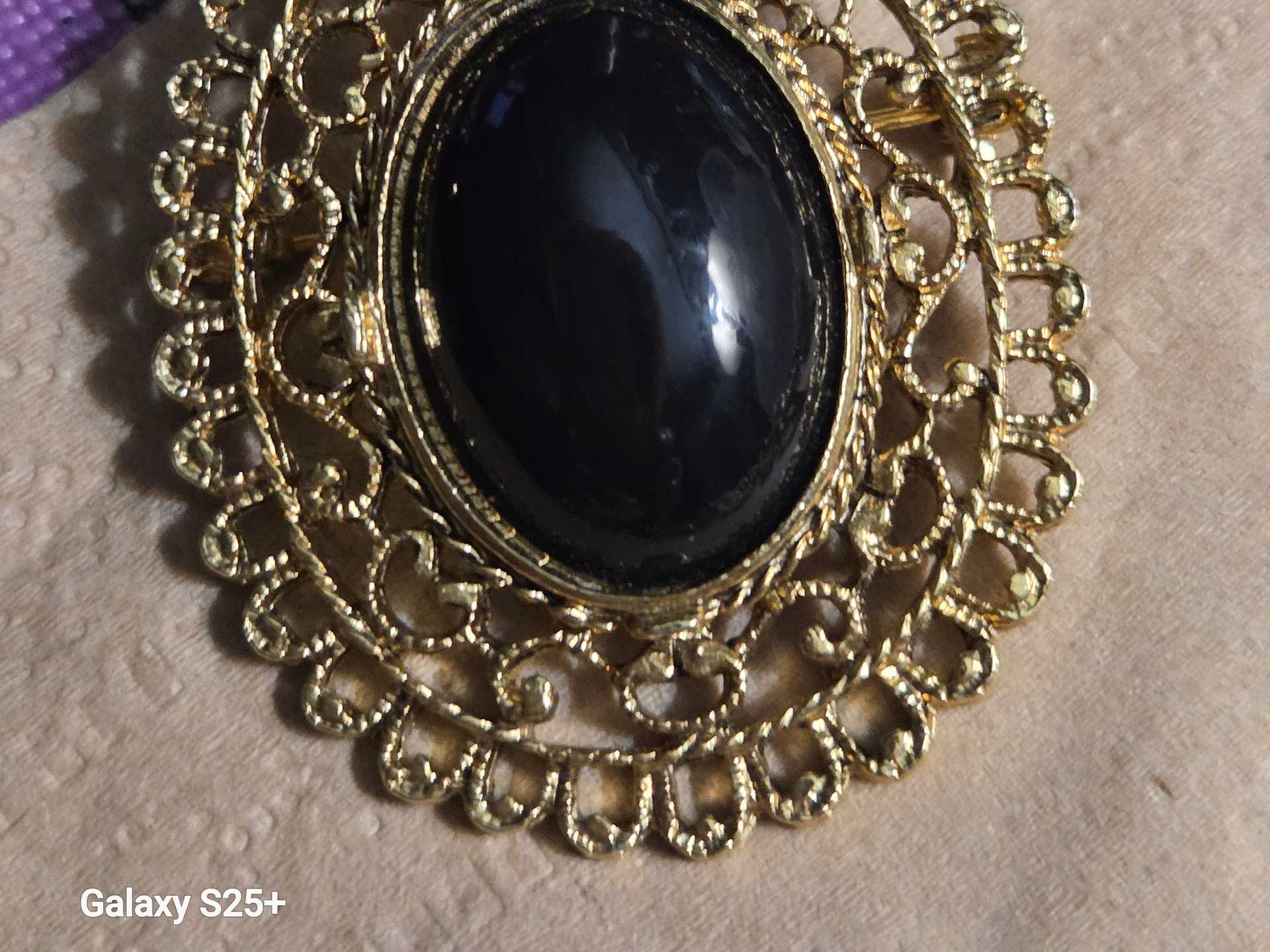 Elegant Gold Oval Black Stone Filigree Brooch