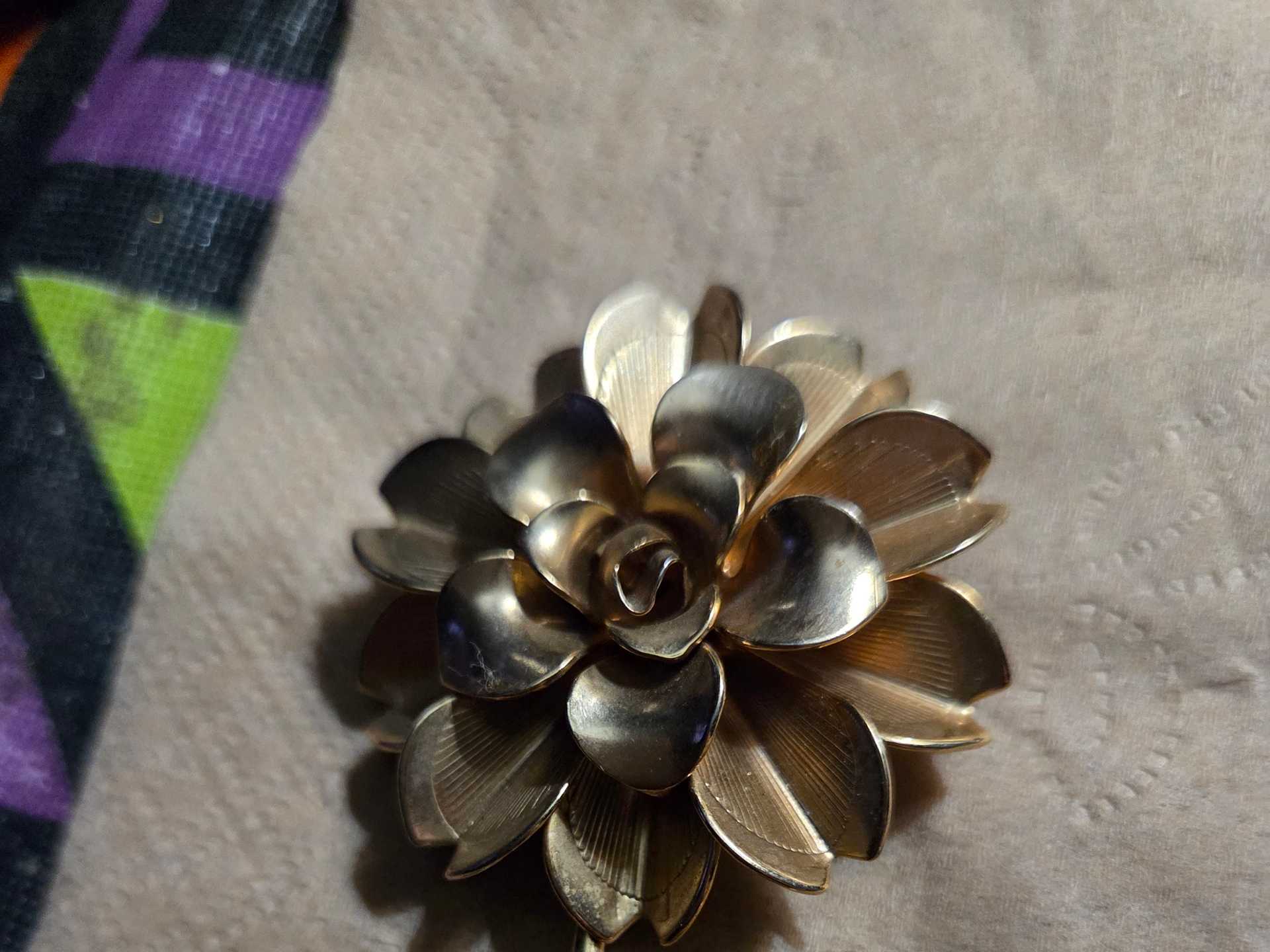 Vintage Golden Flower Brooch with Two Leaves on Textured Fabric