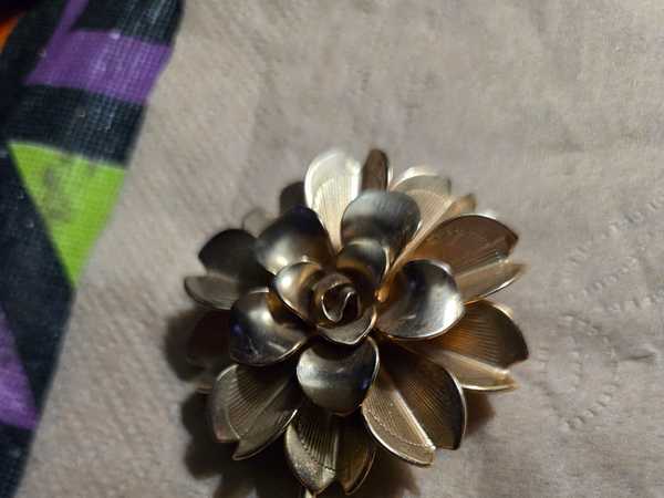 Vintage Golden Flower Brooch with Two Leaves on Textured Fabric